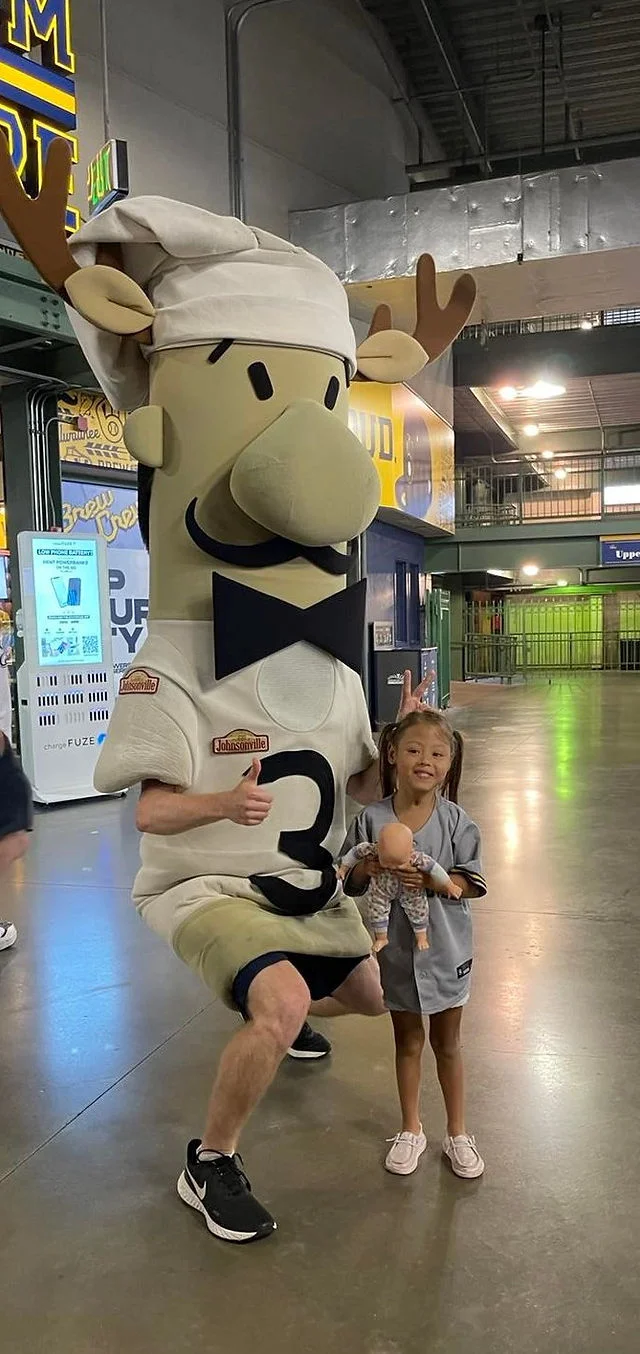 Kid beside the game mascot